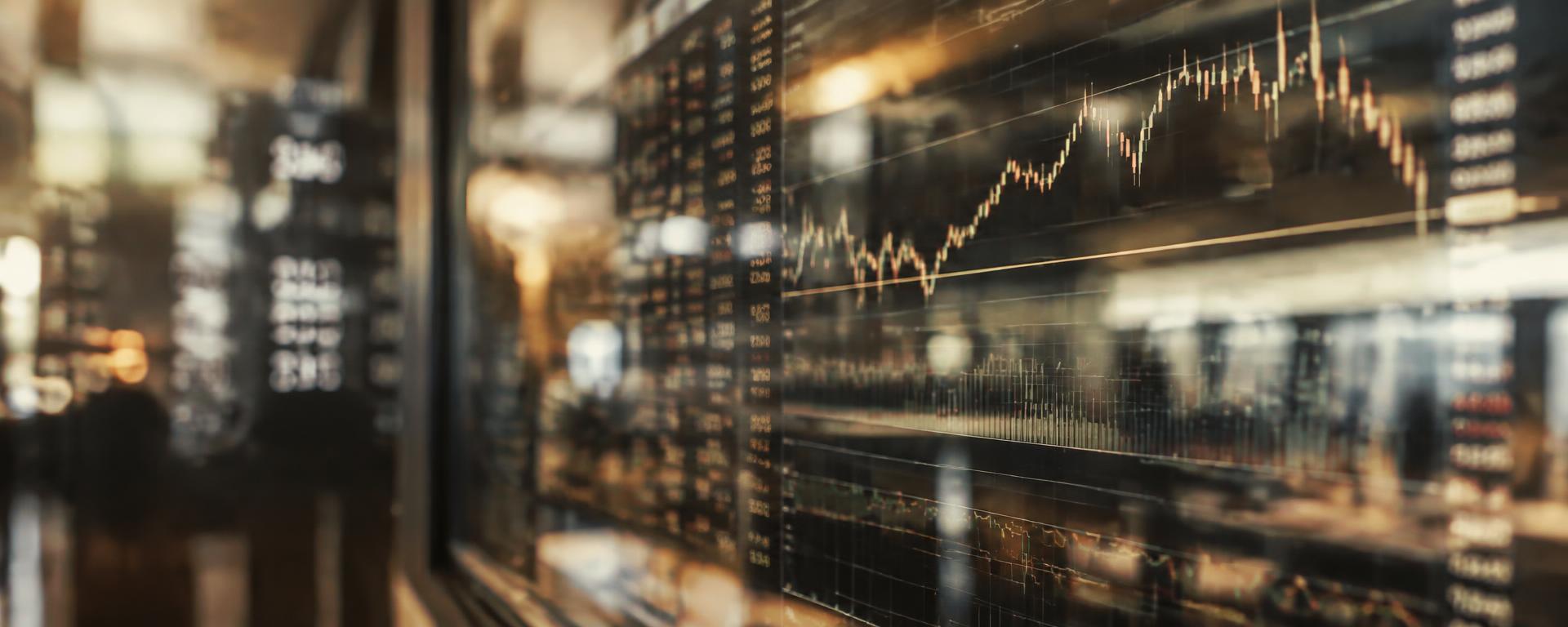 Market charts reflected on glass